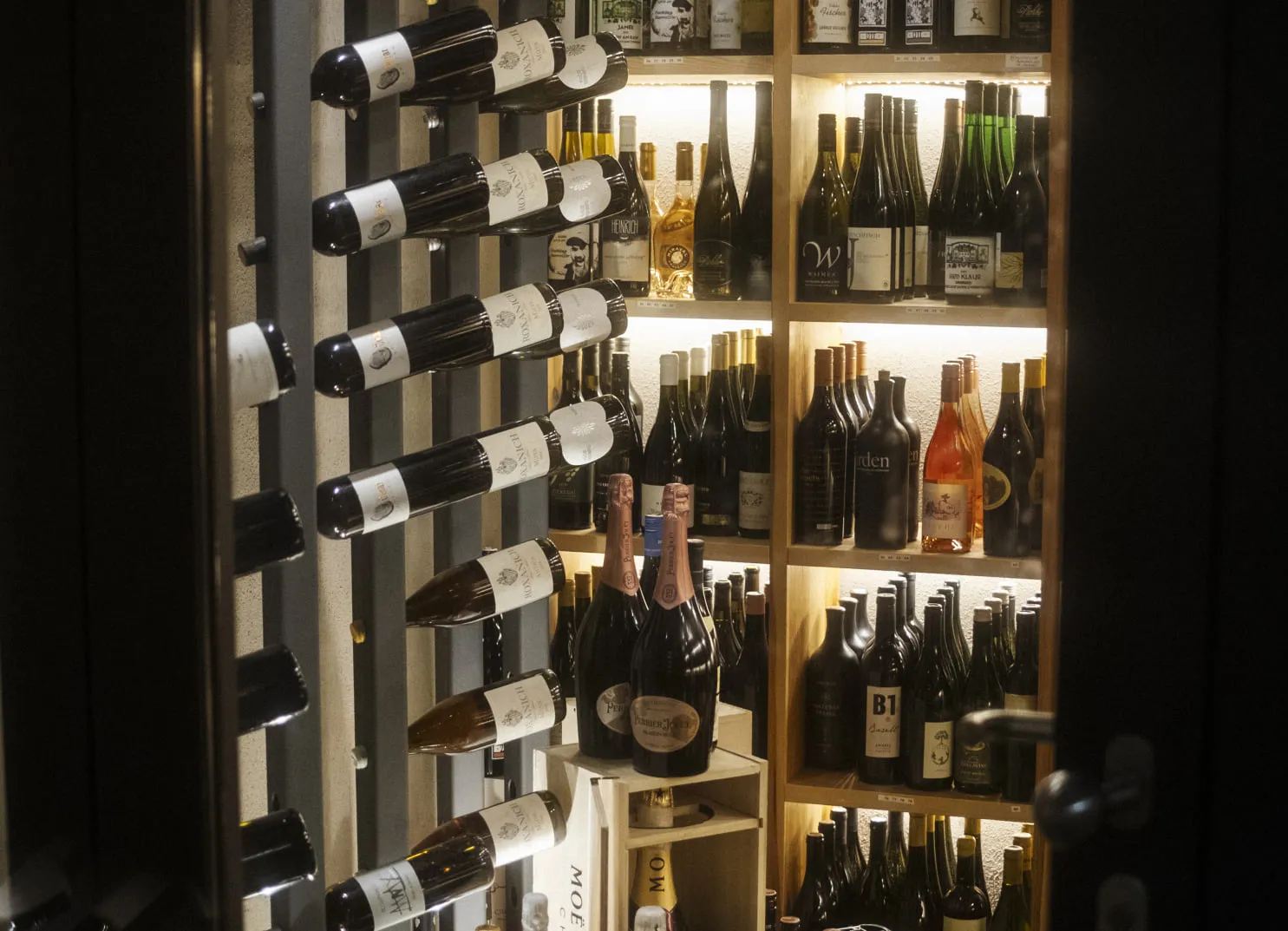 Weinregal mit Flaschen im Holzhotel Forsthofalm